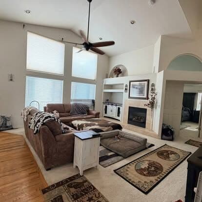 Open living room with vacuumed rugs and dusted surfaces